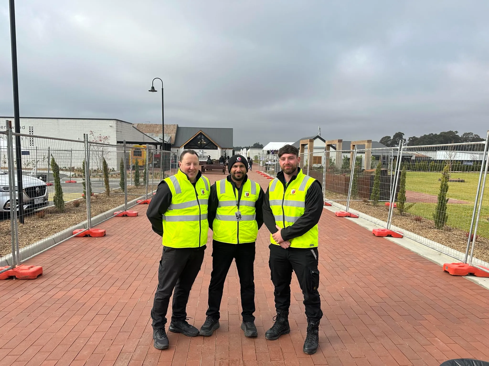 Hi-vis guards walking a path through a new housing estate under construction
