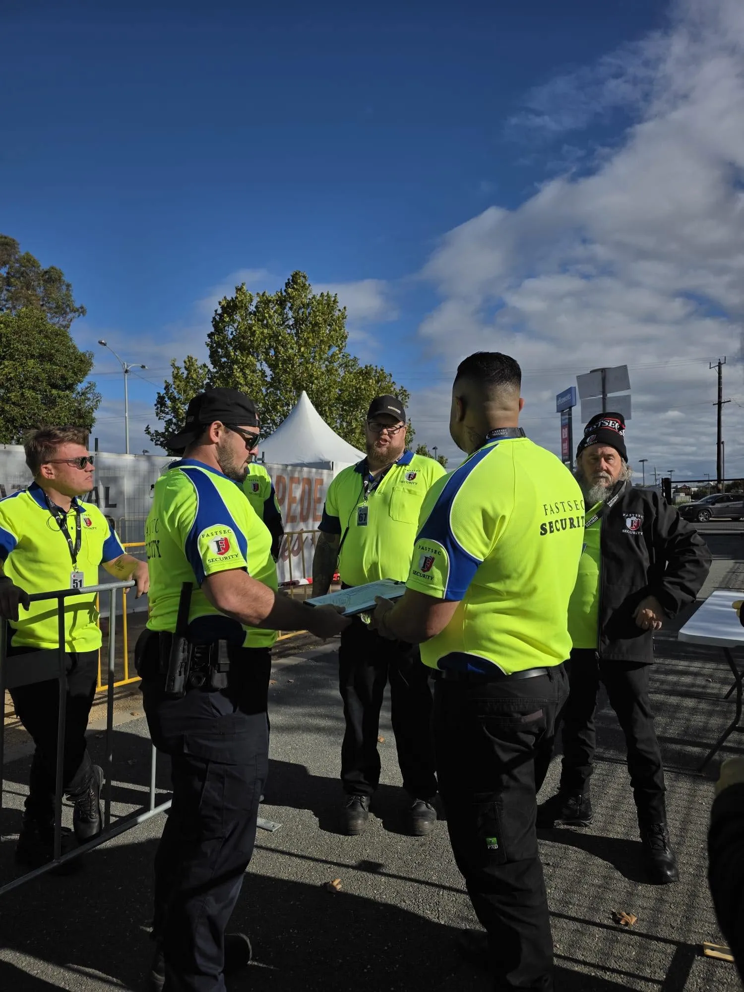 Fastsec Security guards in hi-vis uniform briefing at an event entry point in Shepparton