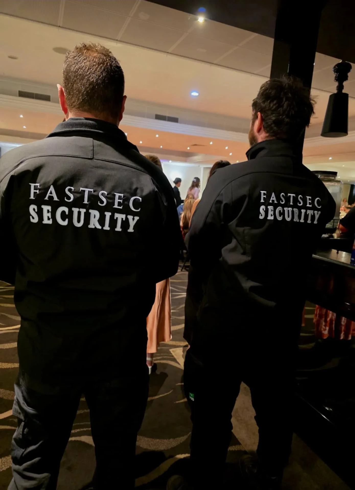 Two Fastsec Security guards watching the floor inside a club venue