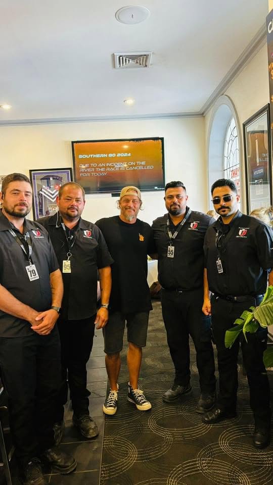 Fastsec Security guards in uniform standing with a patron inside a retail venue in Shepparton